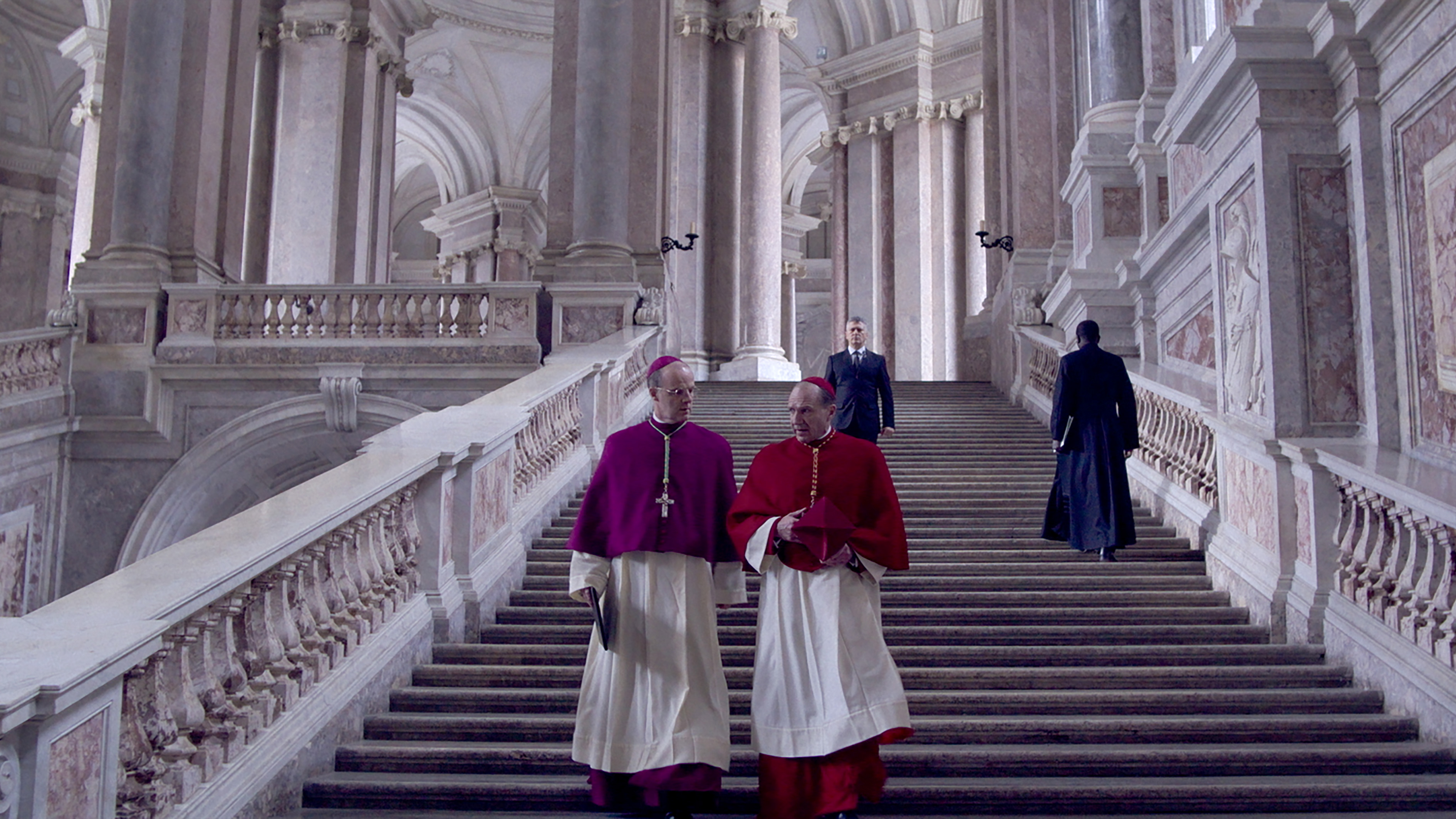(L to R) Brían F. O'Byrne as Cardinal O'Malley and Ralph Fiennes as Cardinal Lawrence in director Edward Berger's CONCLAVE, a Focus Features release. Credit: Courtesy of Focus Features. © 2024 All Rights Reserved.